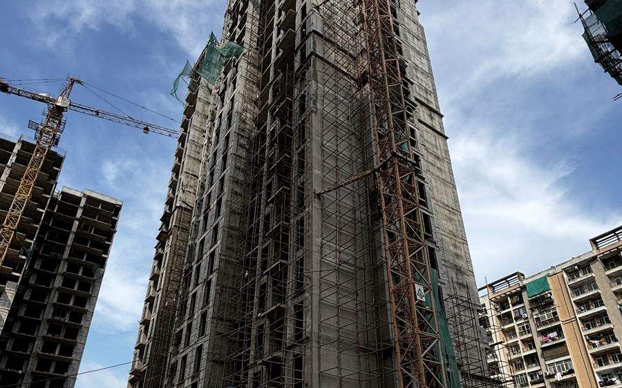 A JDCPL tower under construction, crane in place
